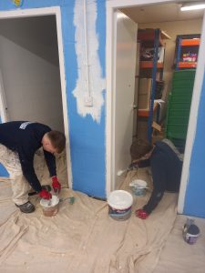 Image showing painting and decorating students at work painting the Doncaster Scout Hut. 