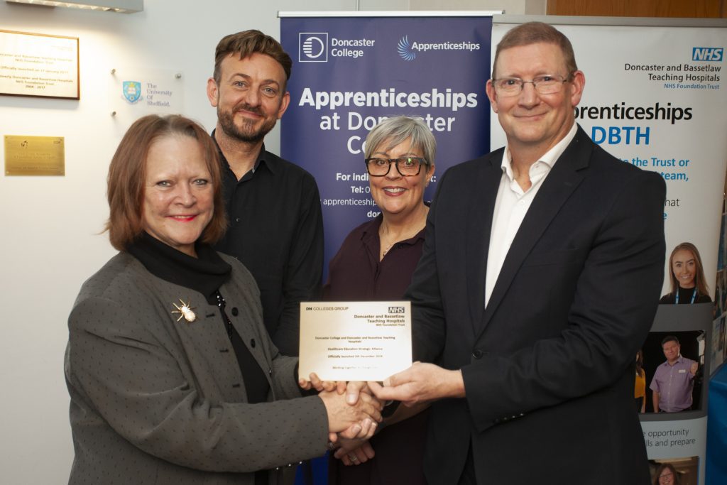 DN College's Group (right) presents a golden plaque indicating the launch of the Doncaster Health Education Strategic Alliance.